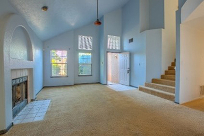 The front entry and living room were nicely distributed but carpeting hid potential.